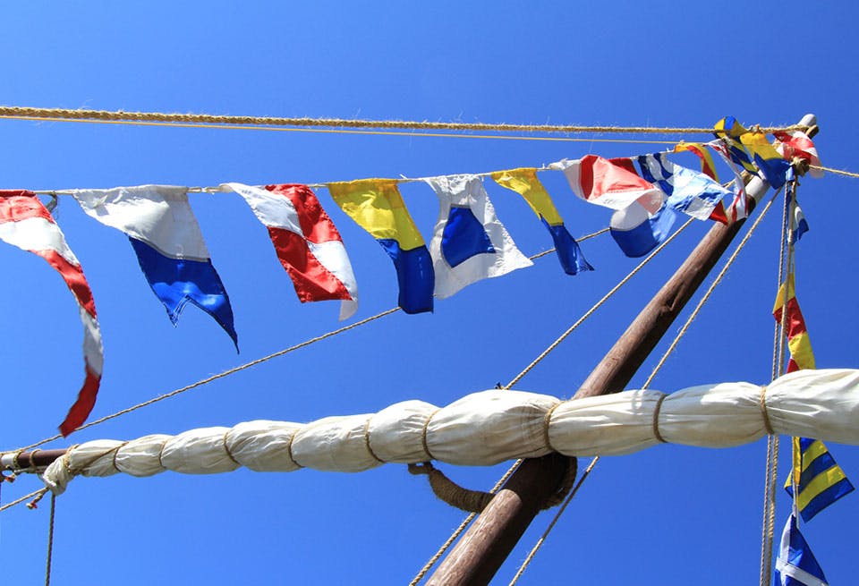 sailing yacht with signal flags